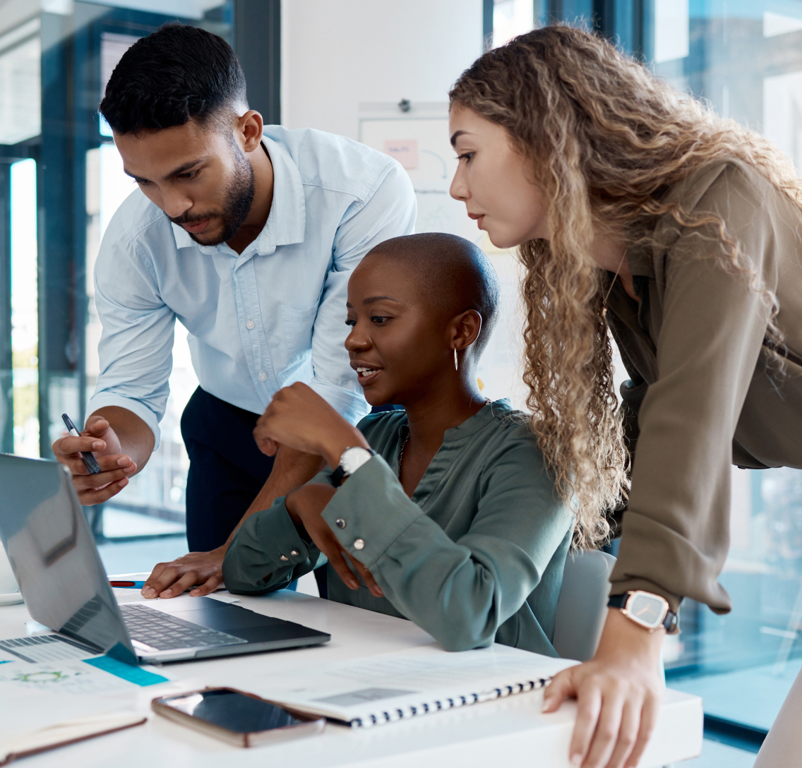 A group of three diverse clinical development workers collaborating on the digital design of a modern clinical trial